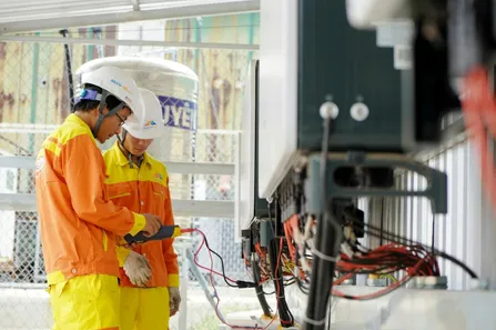 two electricians measuring electrical currents of an infrastructure
