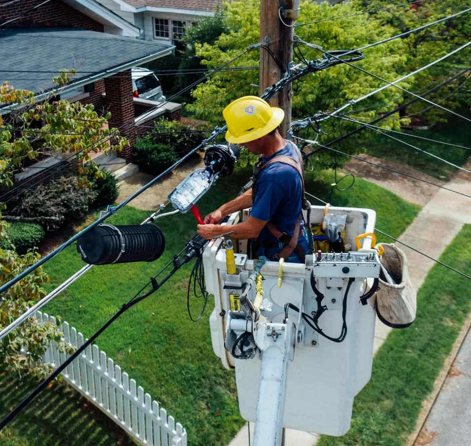 top down view of an electrician working on electrical lines in a lifted bucket